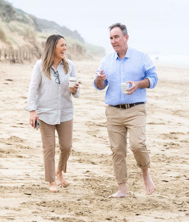 John & Liz, Academy of Raw Potential team, on beach chatting and laughing